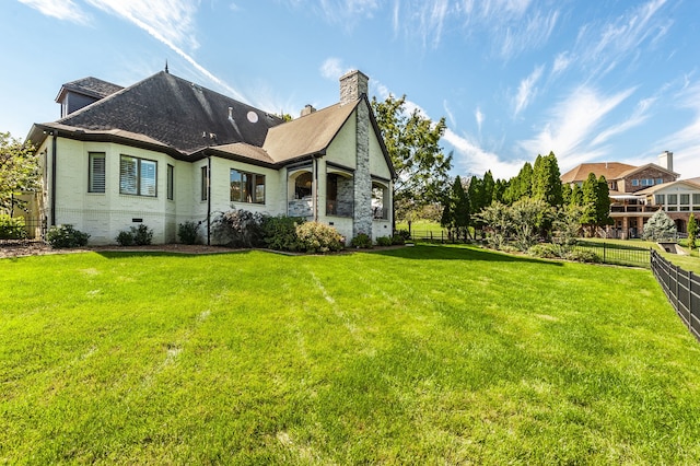 rear view of house featuring a lawn