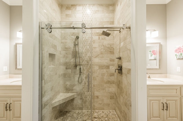 bathroom with a shower with shower door, vanity, and crown molding