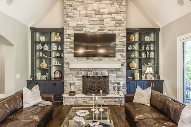 living room featuring a fireplace, dark wood-type flooring, and high vaulted ceiling