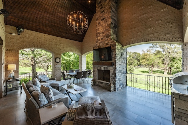 view of patio featuring an outdoor living space with a fireplace