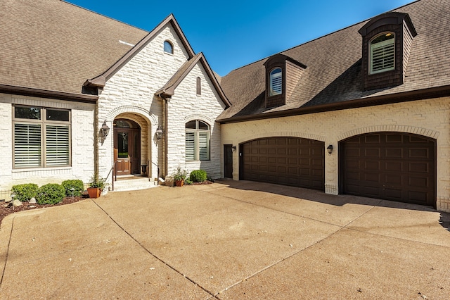 french country inspired facade with a garage