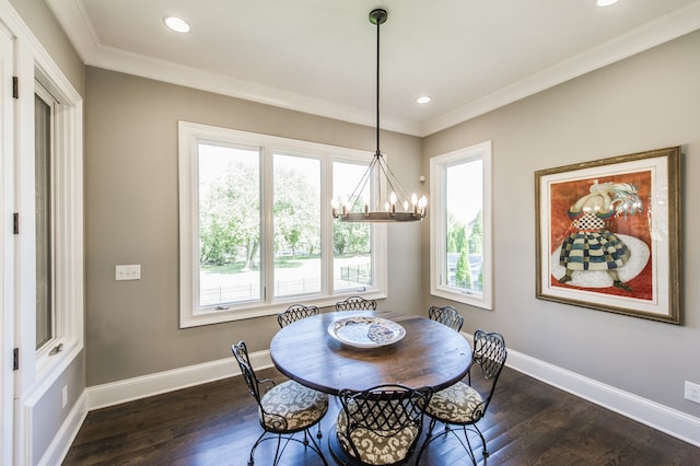 dining room featuring an inviting chandelier, crown molding, and dark hardwood / wood-style flooring