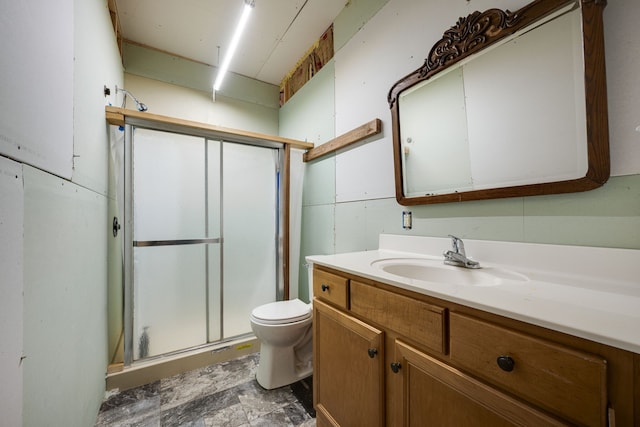 bathroom featuring an enclosed shower, vanity, and toilet