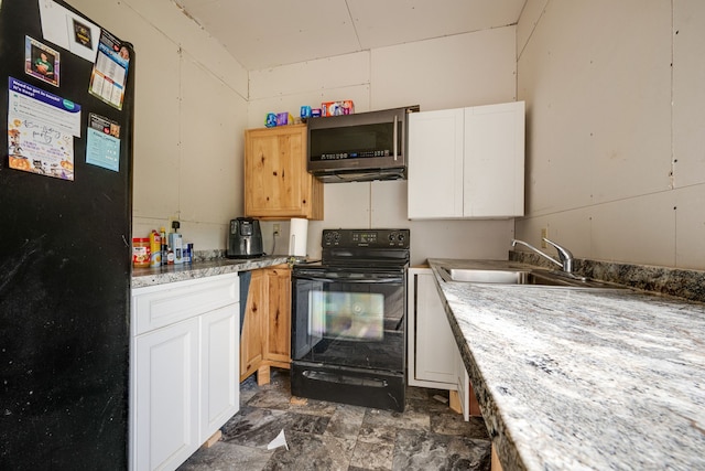 kitchen with light stone countertops, sink, white cabinetry, and black appliances