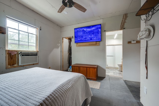 bedroom with ceiling fan, connected bathroom, and concrete flooring