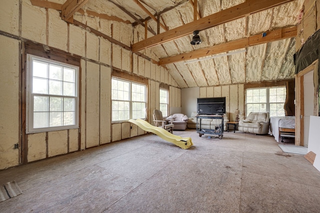 miscellaneous room with lofted ceiling with beams and a wealth of natural light