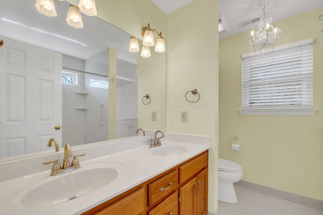 bathroom with vanity, a shower, tile patterned floors, toilet, and a chandelier