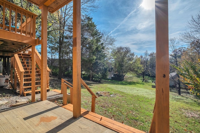 wooden deck featuring a yard