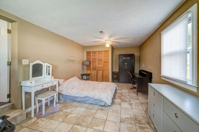 tiled bedroom with a closet and ceiling fan