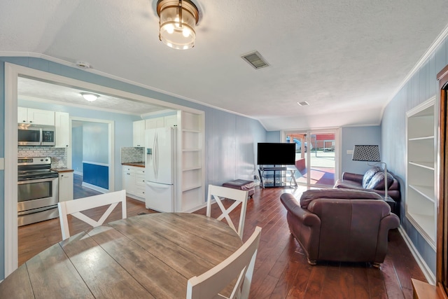 living room featuring ornamental molding, vaulted ceiling, a textured ceiling, and dark hardwood / wood-style flooring