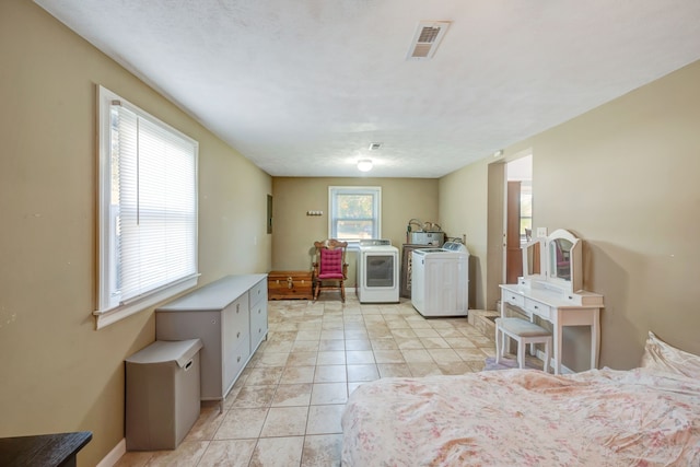 laundry area featuring washer / clothes dryer and light tile patterned floors