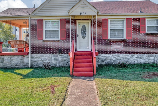 bungalow-style house featuring a front yard