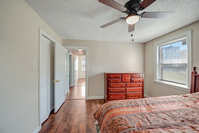 bedroom with a closet, ceiling fan, a textured ceiling, and dark hardwood / wood-style flooring