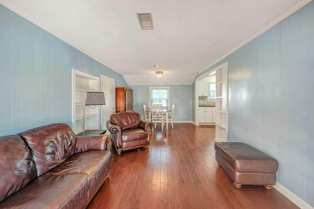 living room with ornamental molding and hardwood / wood-style flooring