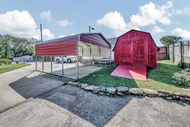 view of outdoor structure featuring a lawn and a carport