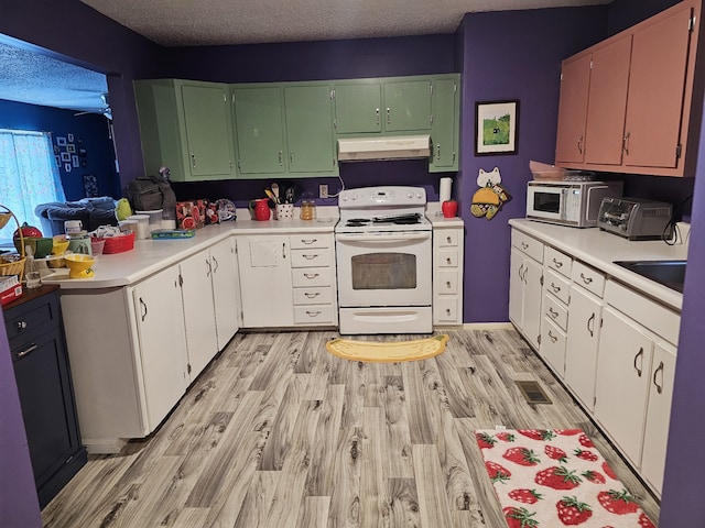 kitchen featuring white cabinets, a textured ceiling, light hardwood / wood-style flooring, and white appliances