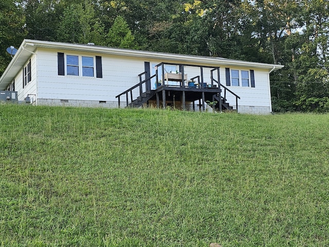 view of front of property with cooling unit and a front lawn