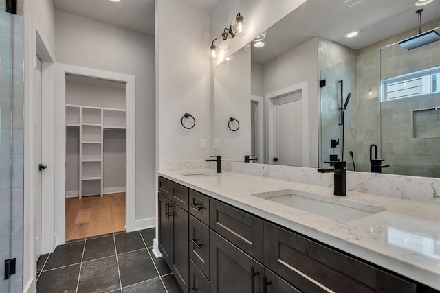 bathroom with vanity, tile patterned flooring, and an enclosed shower