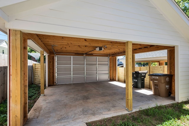 garage with a garage door opener and wood walls