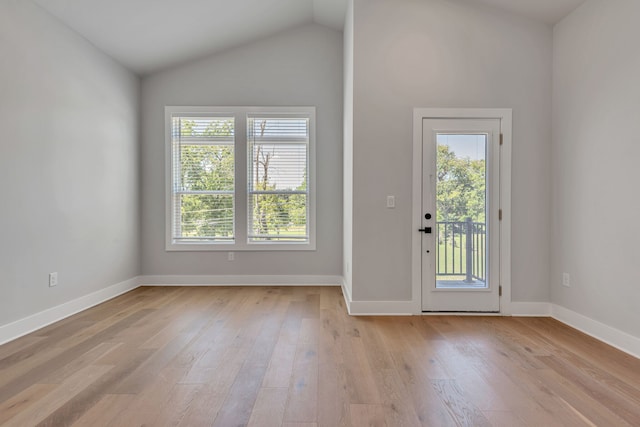 entryway with light hardwood / wood-style flooring and vaulted ceiling