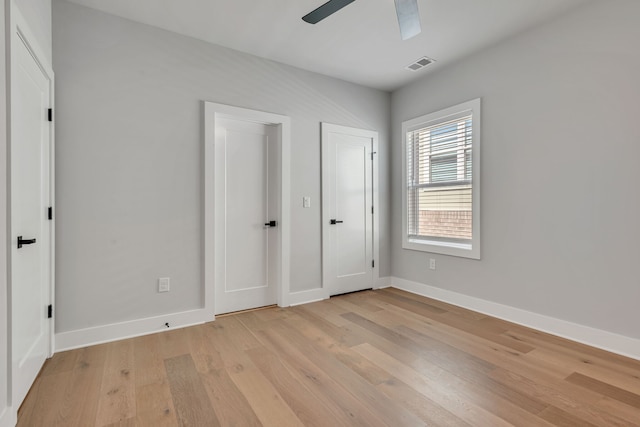 unfurnished bedroom with ceiling fan and light wood-type flooring