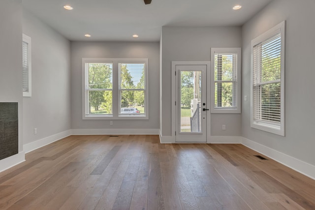 doorway to outside with light hardwood / wood-style floors and a wealth of natural light