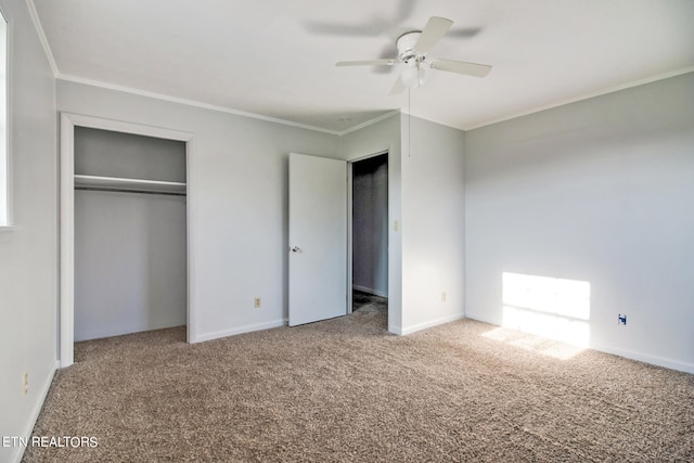 unfurnished bedroom with a closet, ceiling fan, carpet flooring, and crown molding