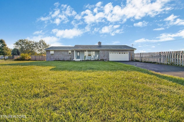single story home with a front yard, an attached garage, fence, and aphalt driveway