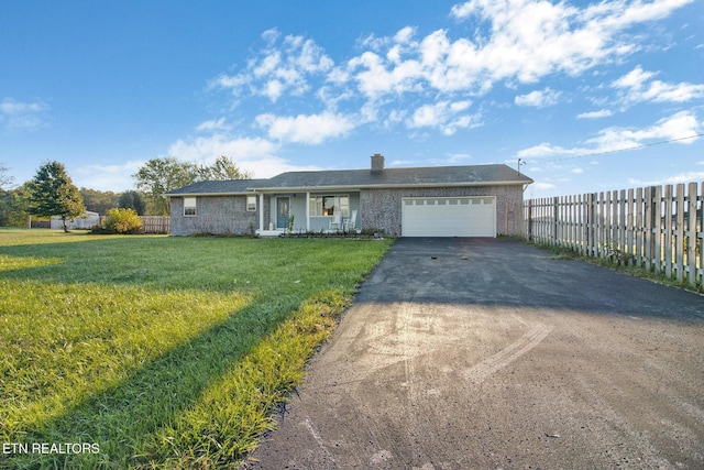 ranch-style house featuring a chimney, driveway, an attached garage, a front lawn, and fence