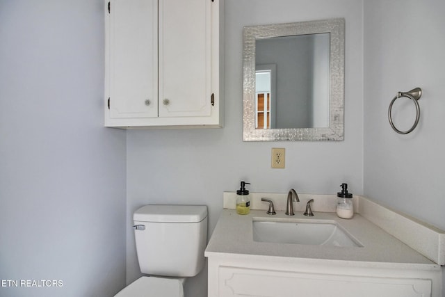 bathroom with toilet and vanity