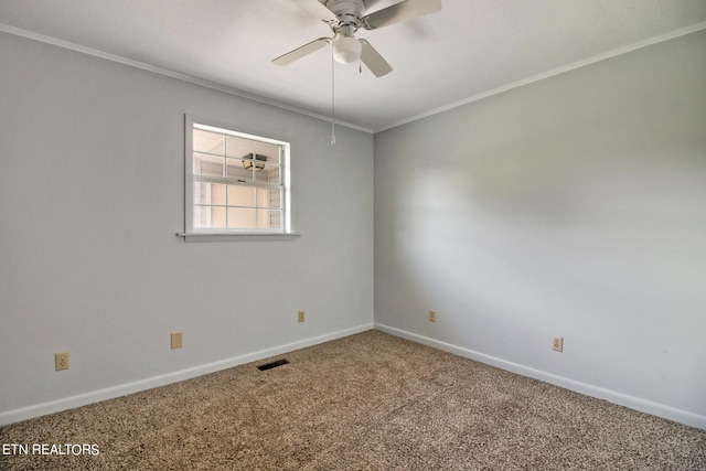 carpeted spare room with crown molding, visible vents, ceiling fan, and baseboards