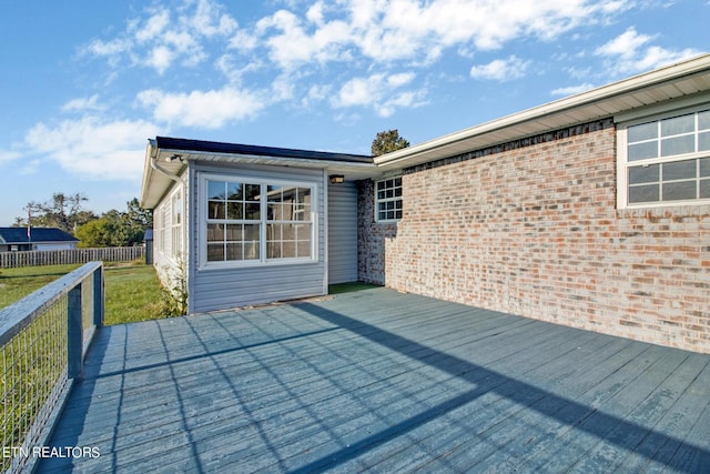 wooden terrace featuring fence