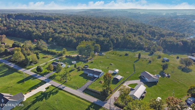 drone / aerial view featuring a wooded view