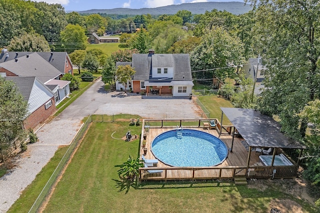 view of swimming pool with a lawn and a deck