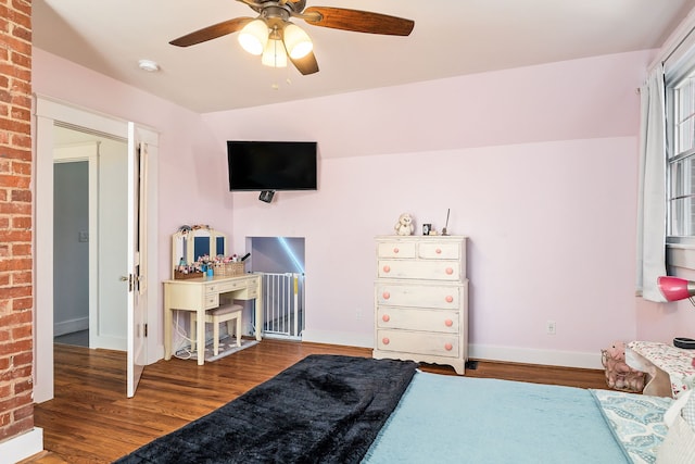 bedroom with vaulted ceiling, dark hardwood / wood-style flooring, and ceiling fan