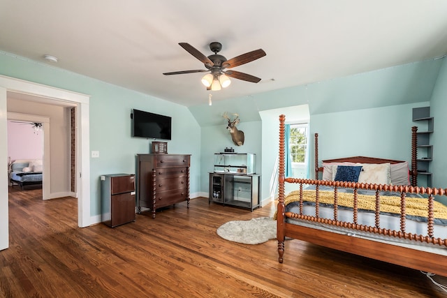 bedroom with ceiling fan, lofted ceiling, and dark wood-type flooring