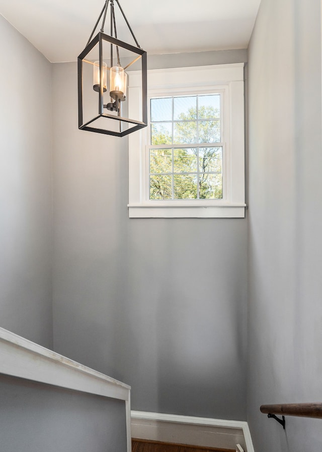 stairway featuring a chandelier and hardwood / wood-style flooring