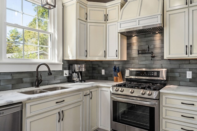 kitchen featuring stainless steel appliances, sink, and tasteful backsplash