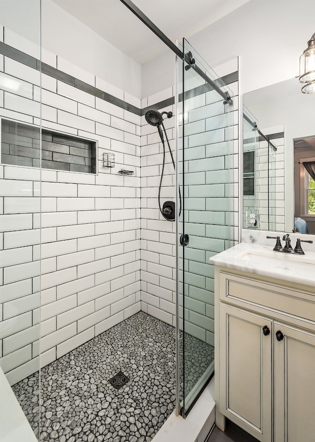 bathroom featuring walk in shower and vanity