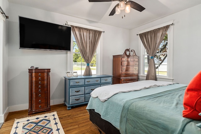 bedroom with wood-type flooring and ceiling fan