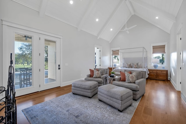 bedroom featuring access to outside, beamed ceiling, hardwood / wood-style flooring, and high vaulted ceiling