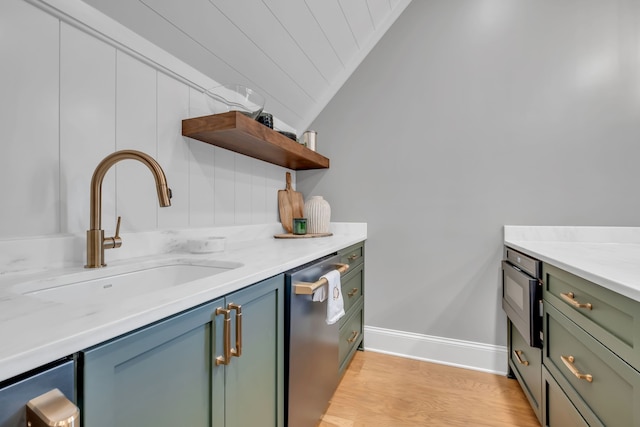 kitchen with light hardwood / wood-style floors, sink, and stainless steel dishwasher