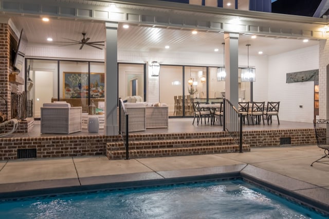 view of swimming pool with an outdoor living space, ceiling fan, and a patio area