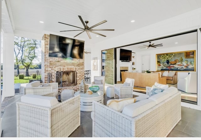 living room featuring wood ceiling, a brick fireplace, ceiling fan, and dark tile patterned floors