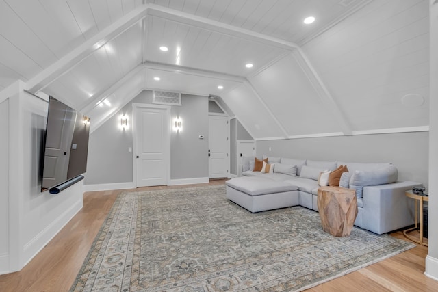 living room featuring light hardwood / wood-style flooring, vaulted ceiling with beams, and wooden ceiling