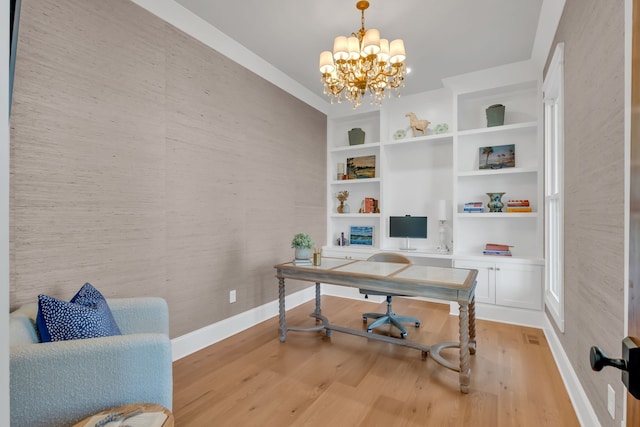 office with built in shelves, a chandelier, and light hardwood / wood-style floors