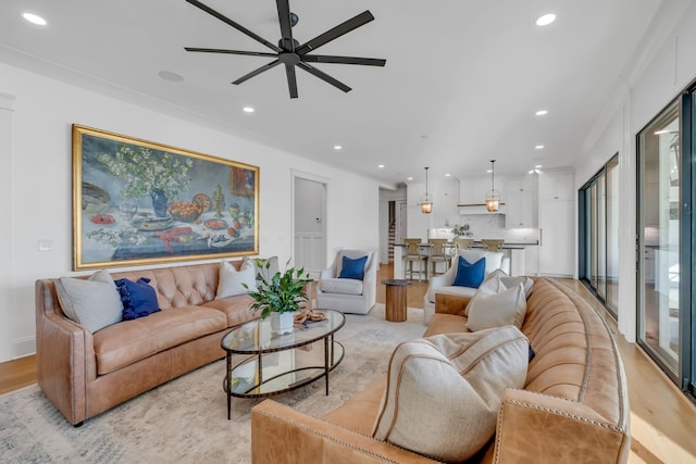 living room with ceiling fan, light hardwood / wood-style flooring, and plenty of natural light