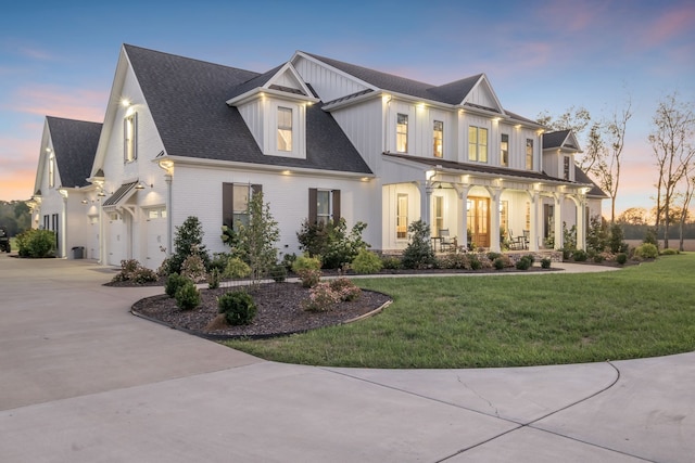 view of front of home with a lawn and a garage