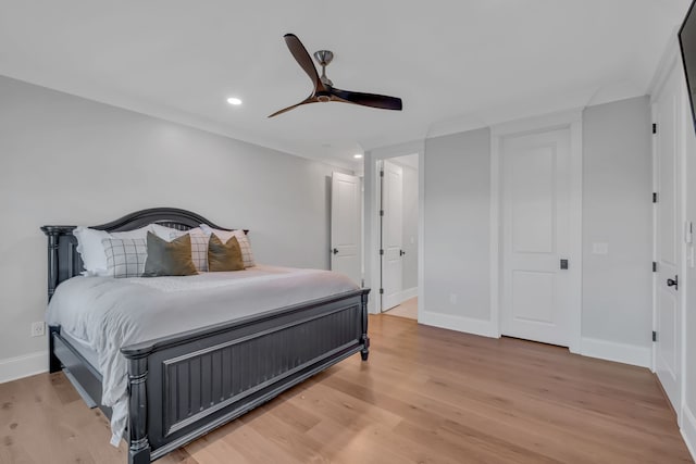 bedroom featuring ceiling fan and light hardwood / wood-style flooring