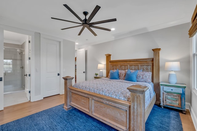 bedroom with ceiling fan, hardwood / wood-style flooring, ensuite bath, and ornamental molding